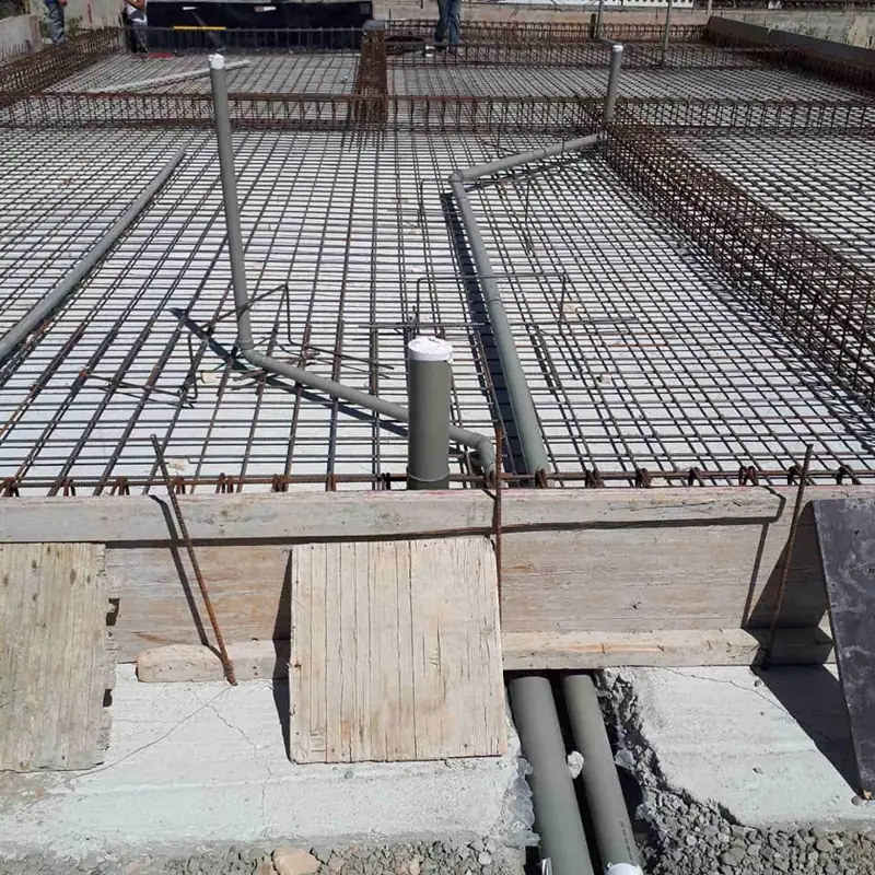 New-build drainage runs through the foundation reinforcement
