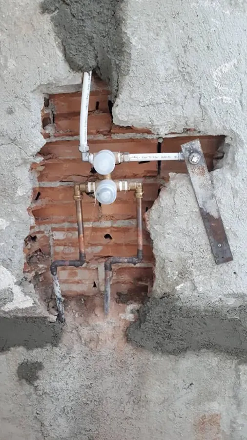 Concealed shower mixer being installed in a bathroom wall
