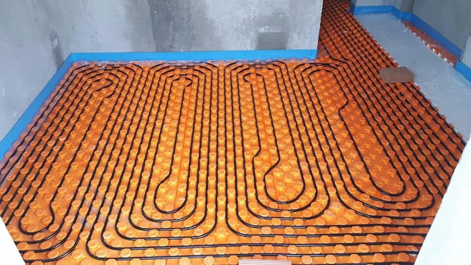 Underfloor heating pipes laid on panel system